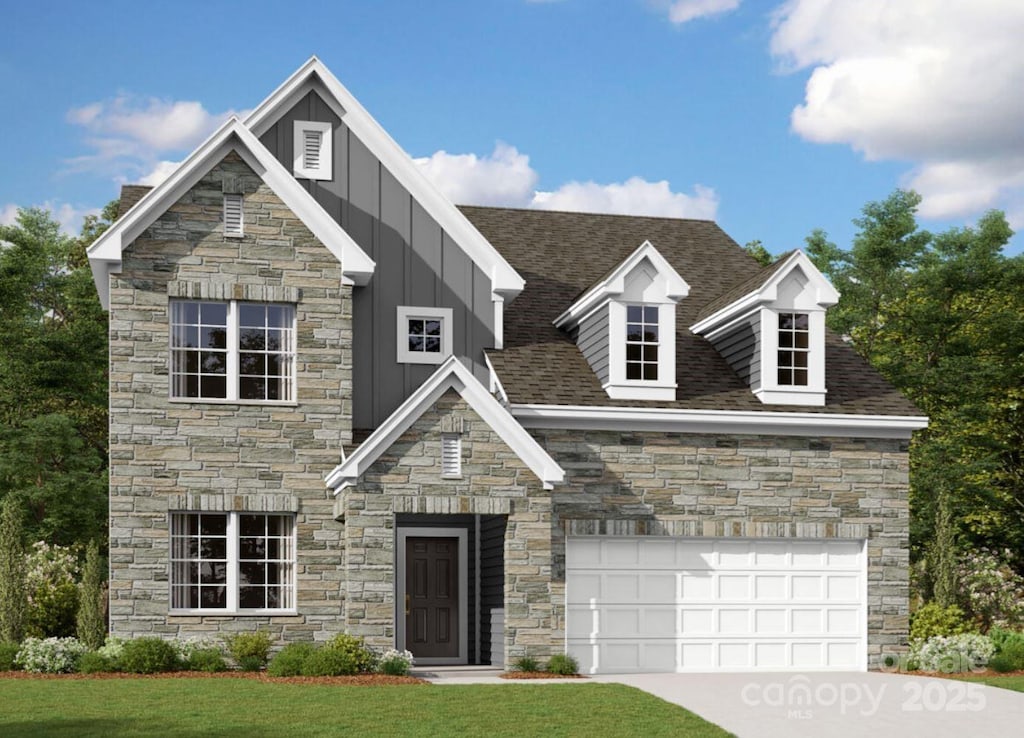 view of front of house with a front lawn and a garage