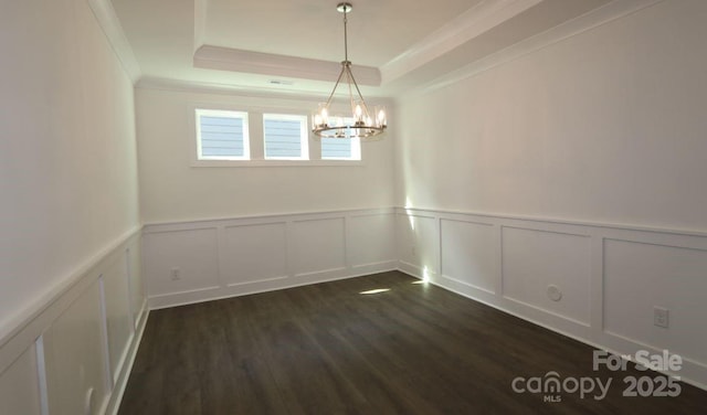 1136 Yellow Springs Dr, Huntersville, NC 28078 - unfurnished dining area with a notable chandelier, a tray ceiling, a decorative wall, ornamental molding, and dark wood finished floors