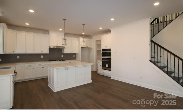 1136 Yellow Springs Dr, Huntersville, NC 28078 - kitchen featuring double oven, tasteful backsplash, gas cooktop, dark wood-style flooring, and recessed lighting