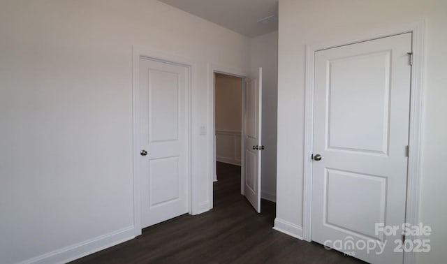 1136 Yellow Springs Dr, Huntersville, NC 28078 - unfurnished bedroom with dark wood-style flooring and baseboards