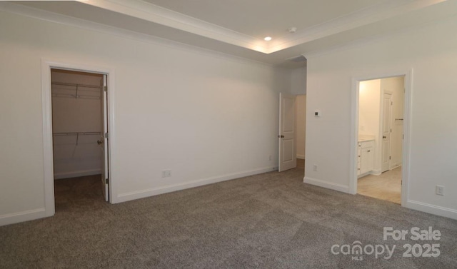 1136 Yellow Springs Dr, Huntersville, NC 28078 - unfurnished bedroom featuring a walk in closet, recessed lighting, ornamental molding, and carpet floors