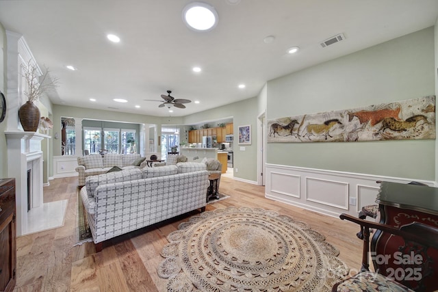 living room featuring ceiling fan and light wood-type flooring