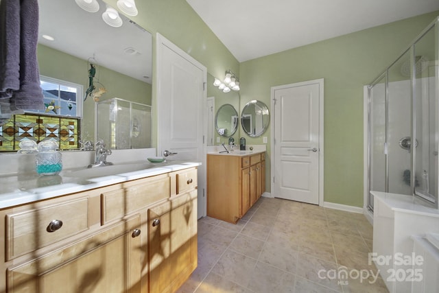 bathroom with tile patterned floors, vanity, and a shower with door