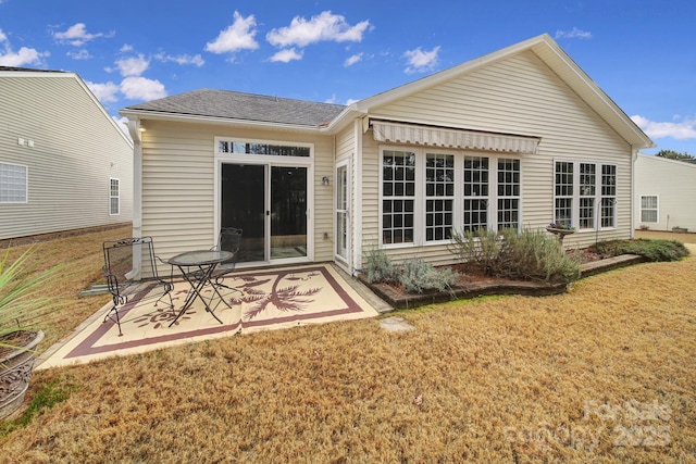 rear view of house with a yard and a patio area