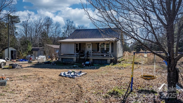 view of front of property featuring a storage unit and covered porch