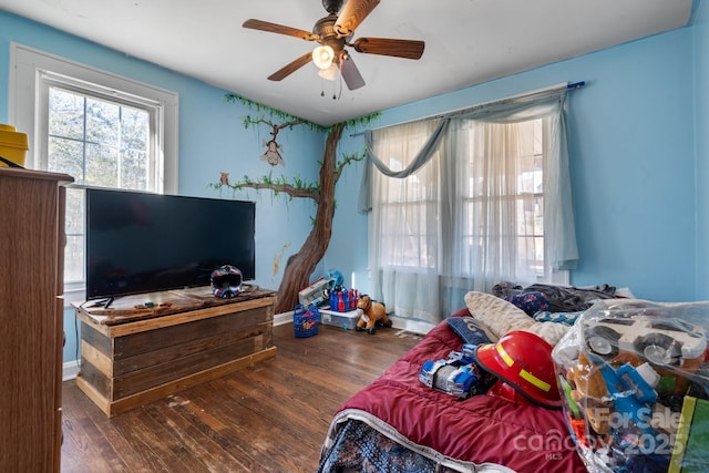 bedroom with dark hardwood / wood-style flooring and ceiling fan