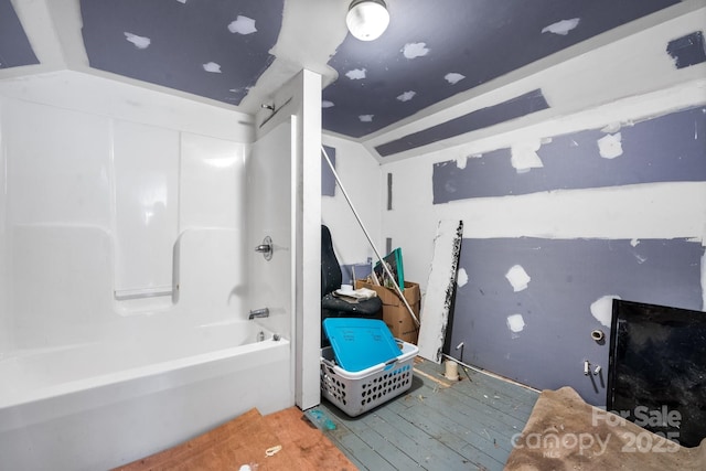 bathroom featuring  shower combination and hardwood / wood-style flooring