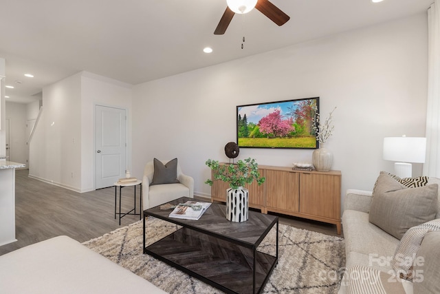 living room featuring ceiling fan and light hardwood / wood-style floors