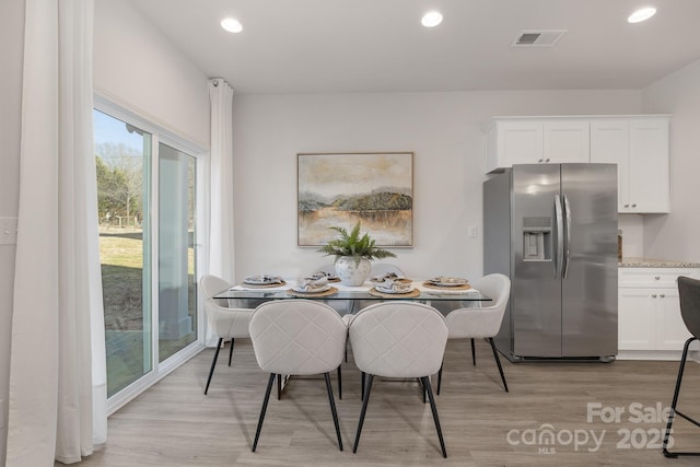 dining area featuring light wood-type flooring