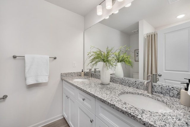 bathroom featuring vanity and toilet