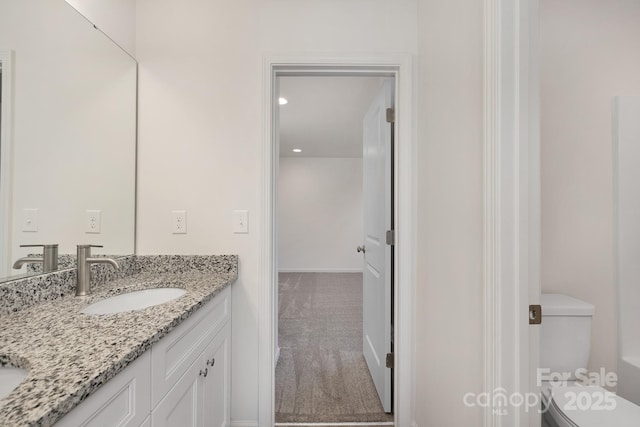 bathroom featuring vanity and toilet