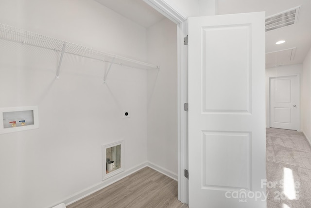 laundry area with washer hookup, light hardwood / wood-style flooring, and electric dryer hookup