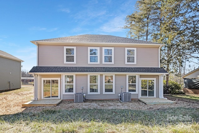 back of house featuring a lawn, a patio area, and central AC unit