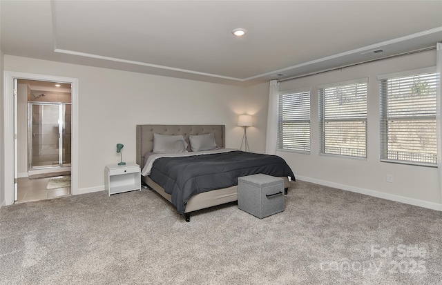 carpeted bedroom featuring ensuite bath