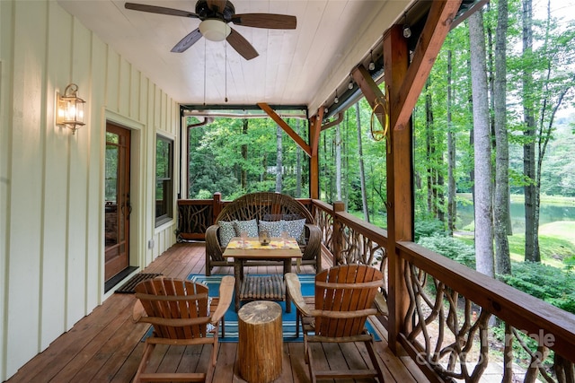 sunroom with ceiling fan, a healthy amount of sunlight, and wood ceiling