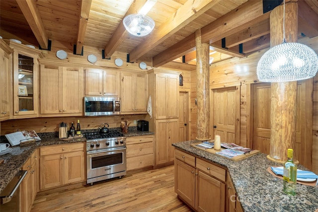 kitchen featuring light brown cabinets, dark stone countertops, light wood-type flooring, appliances with stainless steel finishes, and beam ceiling