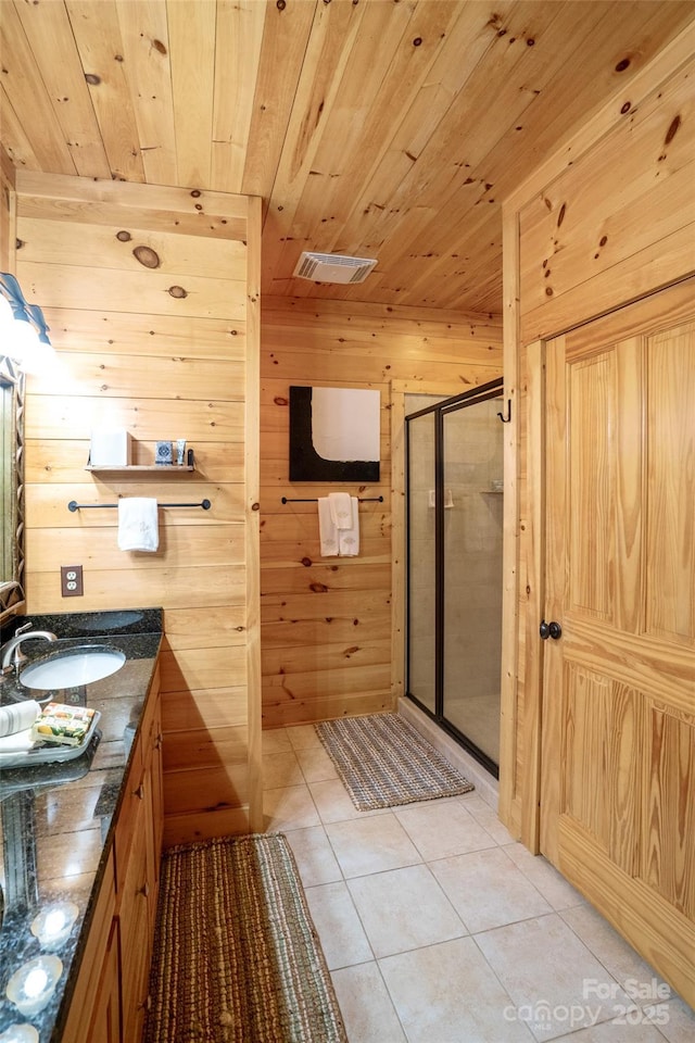 bathroom with wooden ceiling, tile patterned floors, an enclosed shower, wooden walls, and vanity