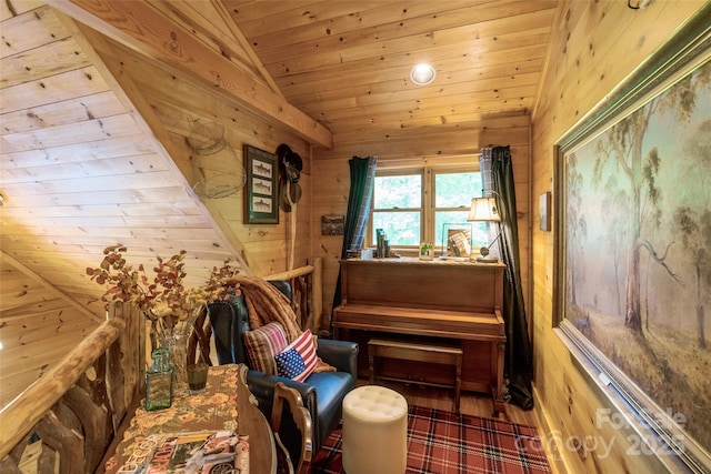 sitting room with wood walls, wood ceiling, and lofted ceiling