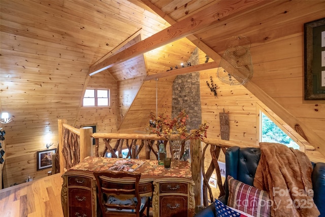 interior space with vaulted ceiling with beams, wood walls, plenty of natural light, and wood ceiling