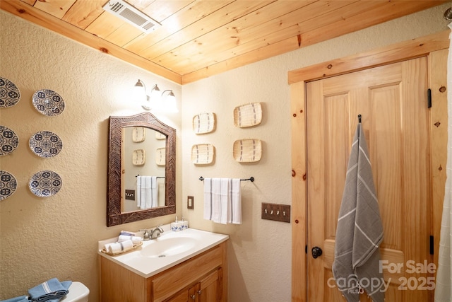 bathroom featuring vanity and wood ceiling