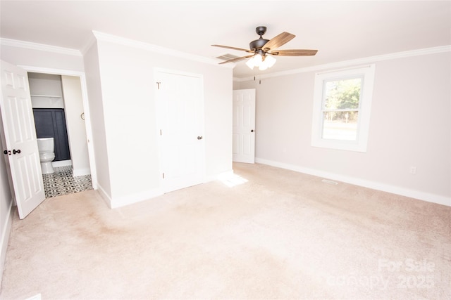 carpeted spare room featuring crown molding and ceiling fan