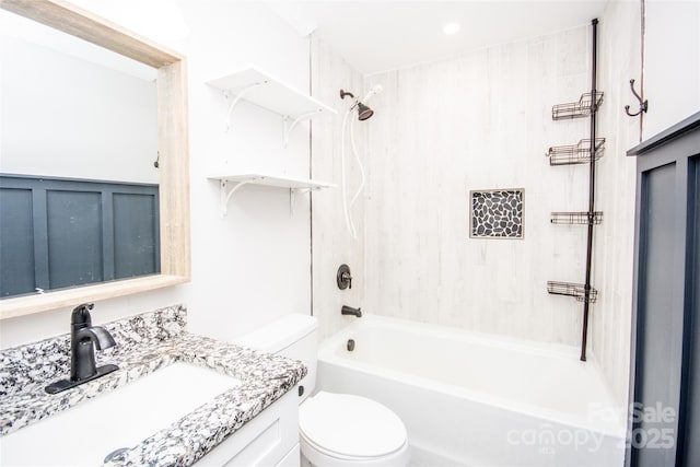 full bathroom with vanity, tiled shower / bath combo, and toilet