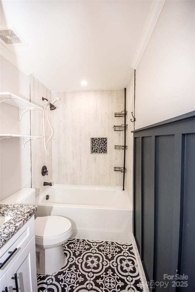 full bathroom featuring tiled shower / bath combo, ornamental molding, tile patterned flooring, vanity, and toilet