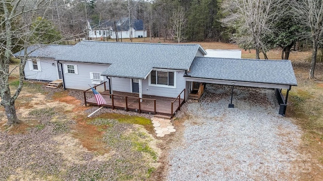 view of front of house with a carport and a deck