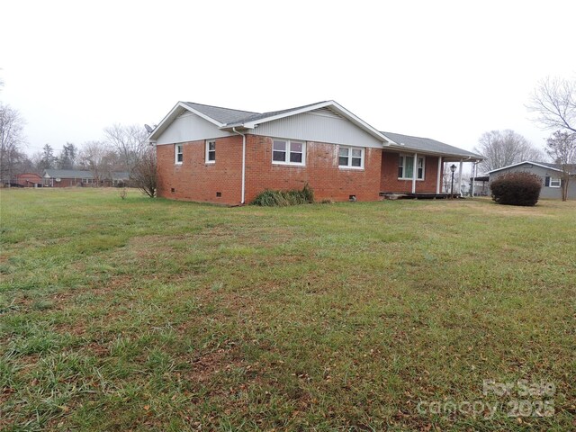 view of side of home with a lawn