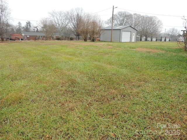 view of yard featuring an outbuilding and a garage