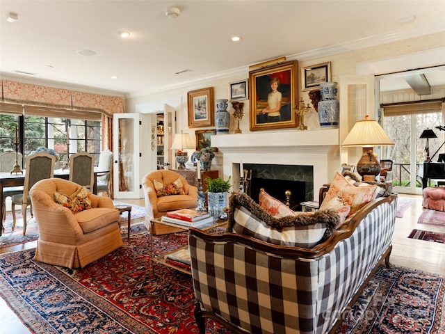 living room featuring a high end fireplace and ornamental molding