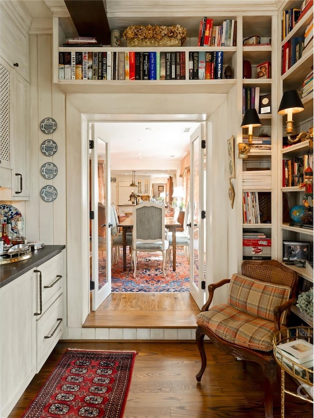 sitting room with wood-type flooring