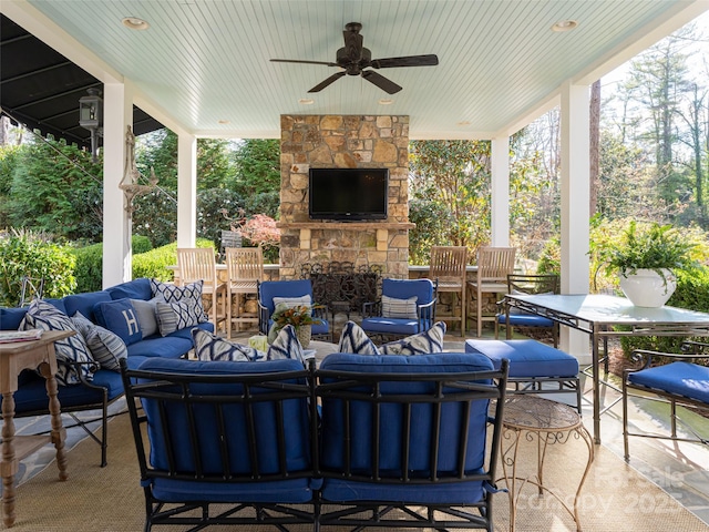 view of patio featuring an outdoor living space with a fireplace and ceiling fan