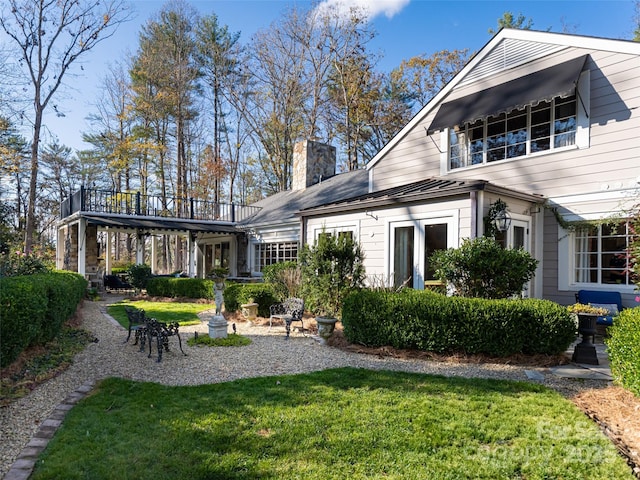 rear view of house with a yard