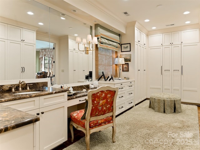 interior space with vanity and ornamental molding