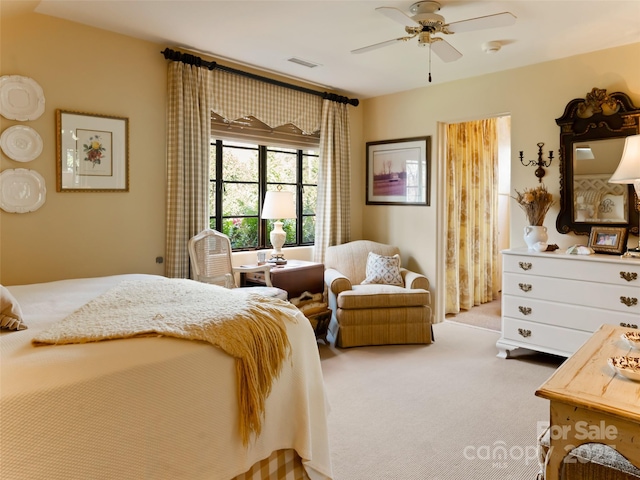 bedroom with ceiling fan and light colored carpet