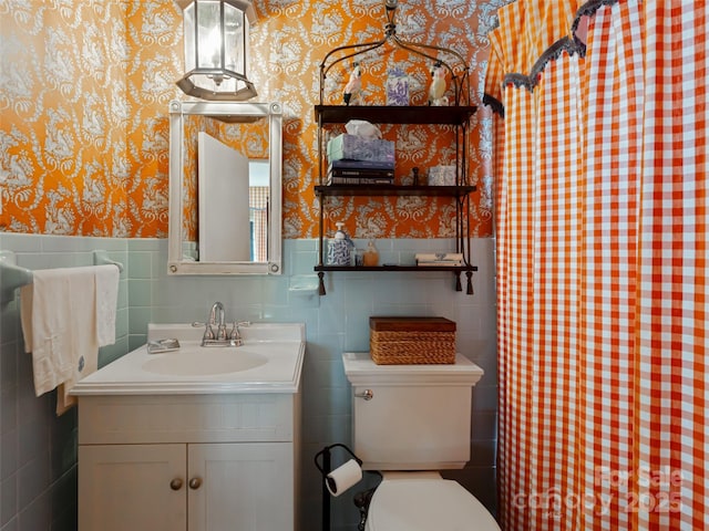 bathroom featuring vanity, toilet, and walk in shower