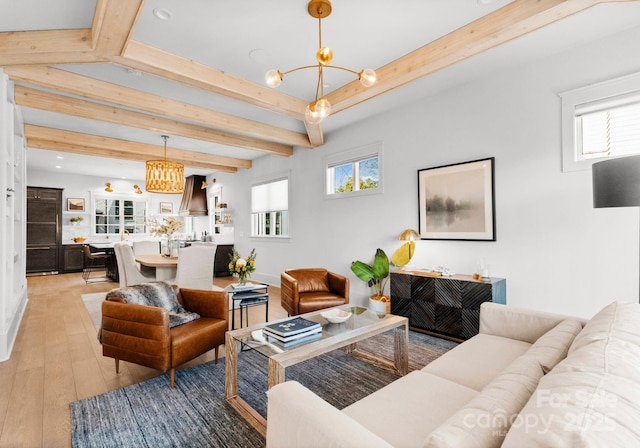 living room featuring beam ceiling, light wood-type flooring, and a chandelier