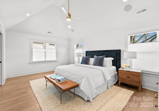 bedroom with ceiling fan, light hardwood / wood-style flooring, and vaulted ceiling