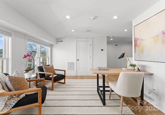 home office featuring light wood-type flooring and vaulted ceiling