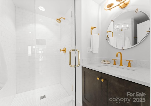 bathroom with vanity and an enclosed shower