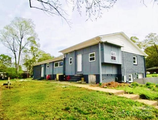 back of property featuring a lawn