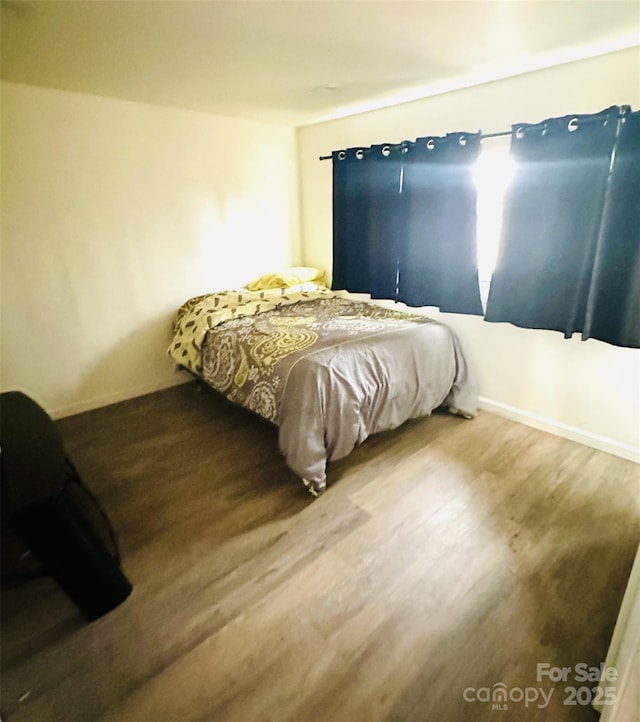 bedroom with wood-type flooring