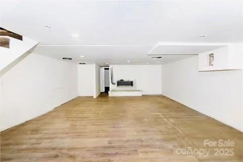 basement with hardwood / wood-style floors