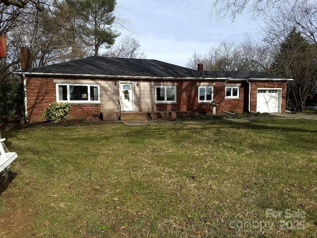 rear view of property with a yard and a garage