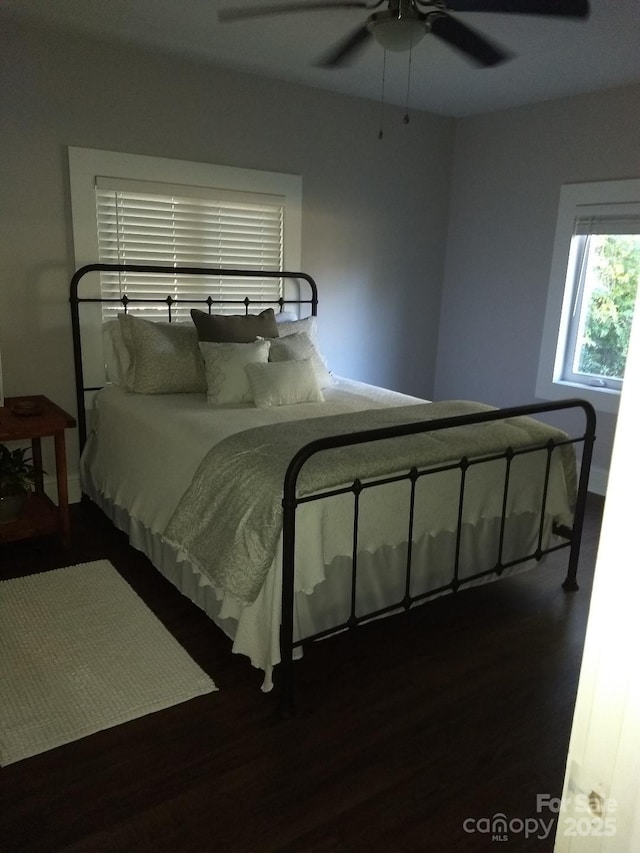 bedroom featuring ceiling fan and dark hardwood / wood-style flooring