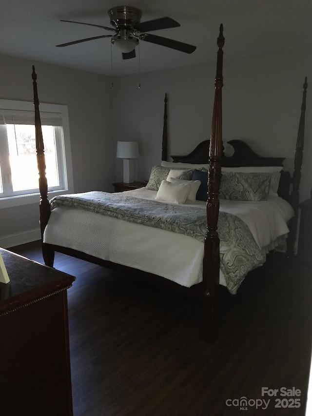 bedroom featuring ceiling fan and dark hardwood / wood-style floors