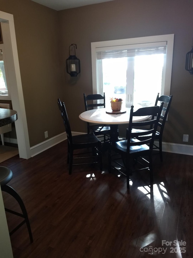 dining area featuring dark hardwood / wood-style flooring