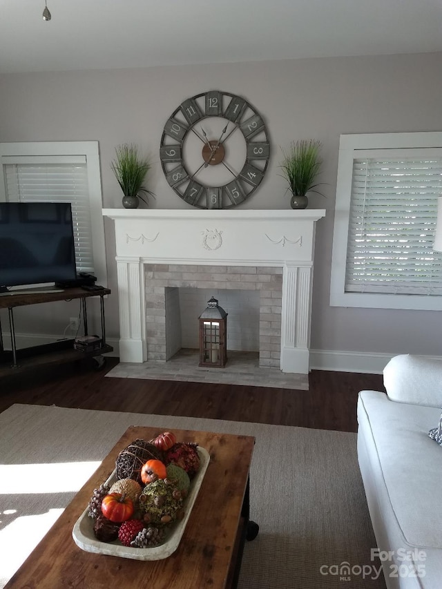 living room featuring a fireplace and dark hardwood / wood-style floors