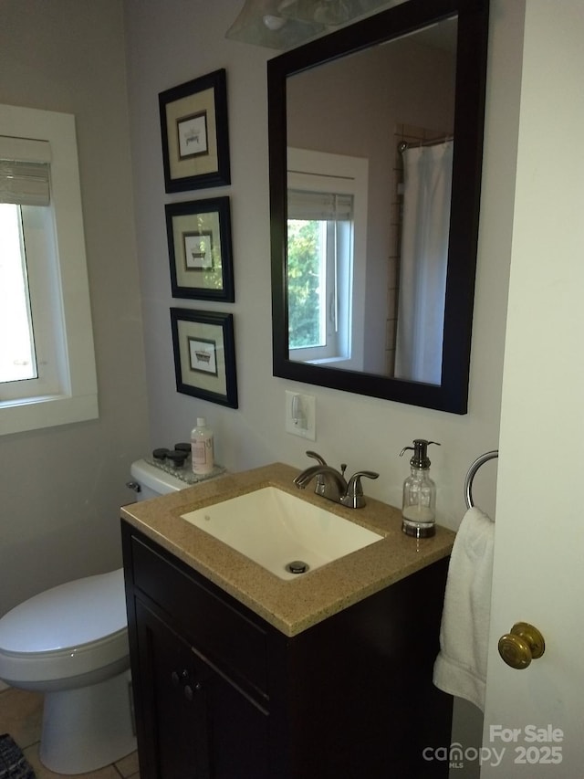 bathroom featuring vanity and toilet